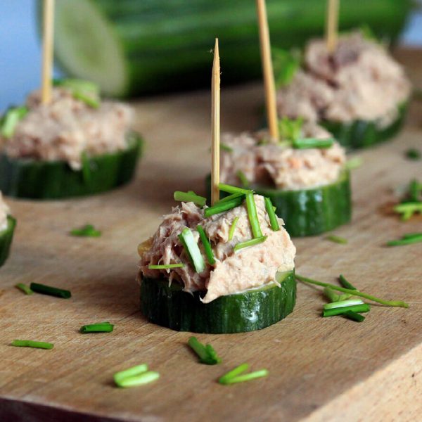 Beautifully plated canapés on a wooden board